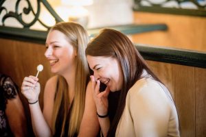 two women laughing in booth