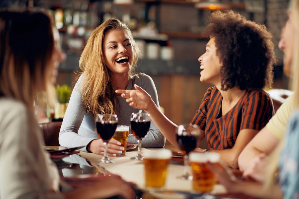 women wine table talking