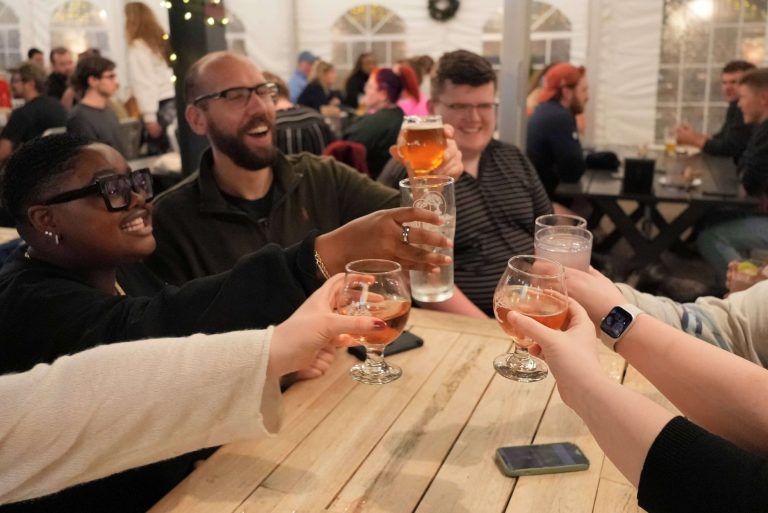Friends toasting drinks during trivia night at MadTree Brewing in Cincinnati Ohio